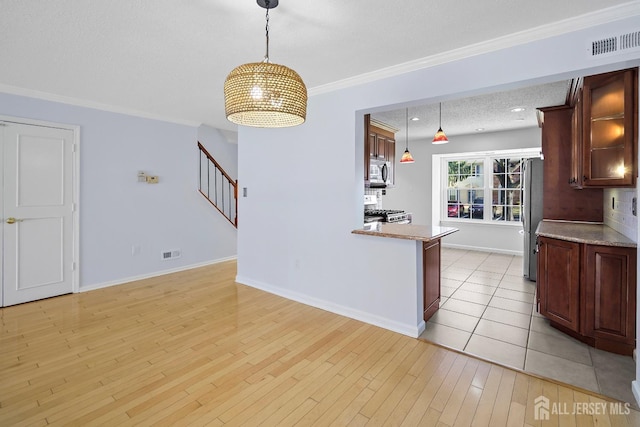 18 Albury Way N, Brunswick, NJ 08902 - kitchen featuring stainless steel appliances, light wood-style flooring, pendant lighting, light countertops, and baseboards
