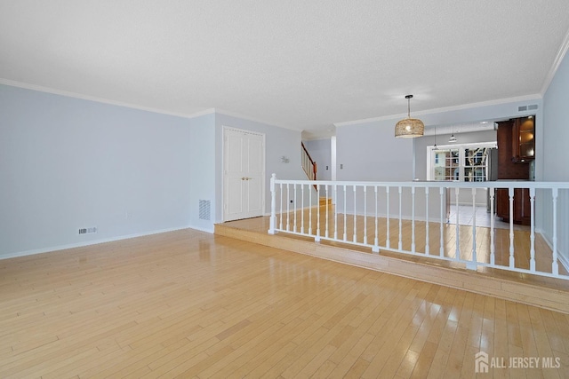 18 Albury Way N, Brunswick, NJ 08902 - spare room with hardwood / wood-style floors, ornamental molding, stairs, and baseboards