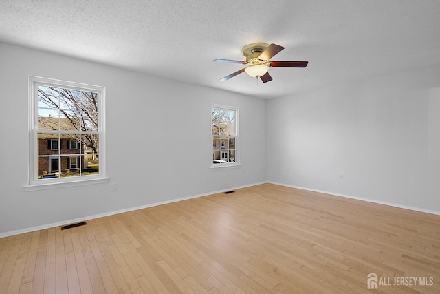 18 Albury Way N, Brunswick, NJ 08902 - empty room with a ceiling fan, light wood-style flooring, baseboards, and a textured ceiling
