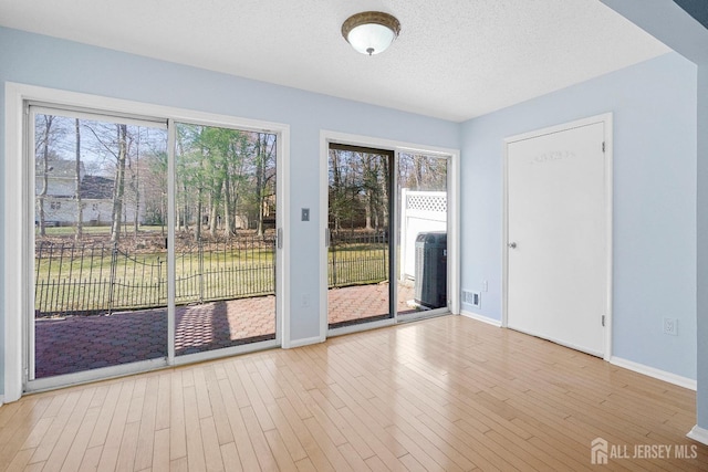 18 Albury Way N, Brunswick, NJ 08902 - doorway featuring baseboards, wood finished floors, and a textured ceiling