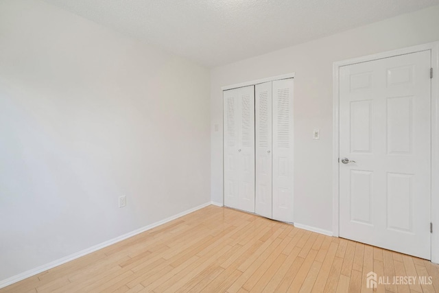 18 Albury Way N, Brunswick, NJ 08902 - unfurnished bedroom featuring light wood-style flooring, baseboards, and a closet