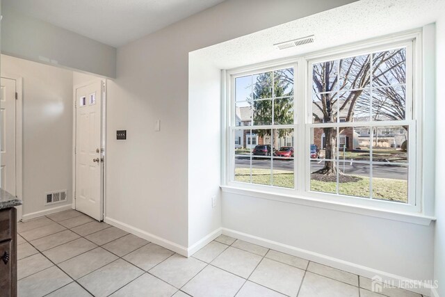 18 Albury Way N, Brunswick, NJ 08902 - unfurnished dining area with light tile patterned floors and baseboards