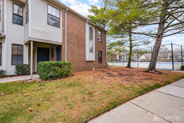 view of side of home with a yard