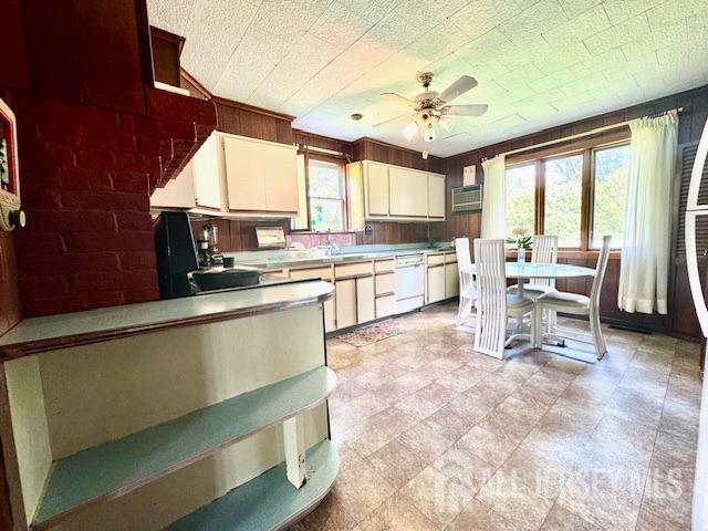 kitchen featuring white dishwasher, white cabinetry, ceiling fan, and sink