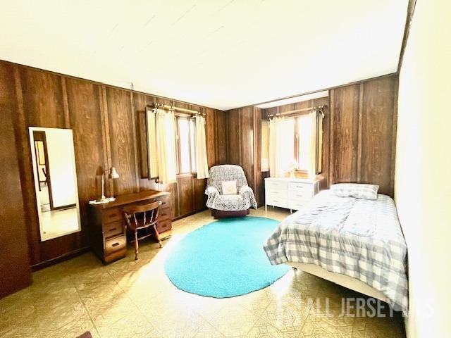 bedroom with wooden walls