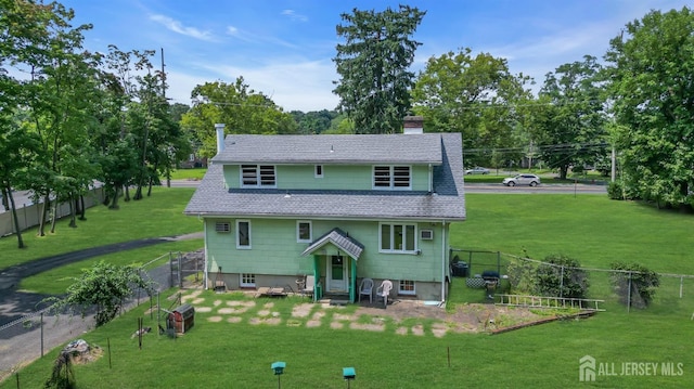 rear view of house featuring a lawn