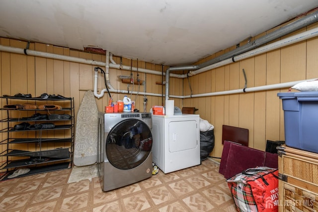 laundry room featuring washing machine and clothes dryer, tile patterned floors, and laundry area
