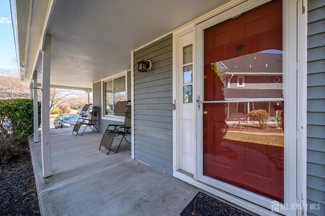 view of exterior entry with a porch