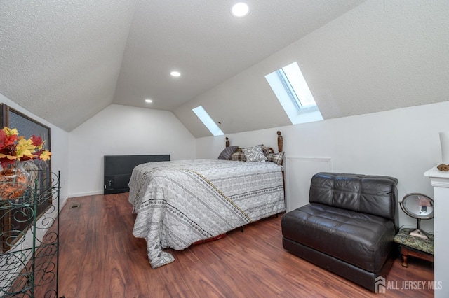 bedroom featuring recessed lighting, wood finished floors, lofted ceiling with skylight, baseboards, and a textured ceiling