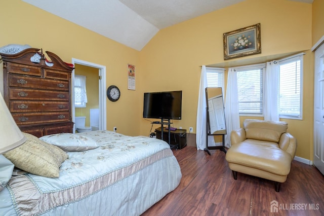 bedroom with lofted ceiling, baseboards, and wood finished floors
