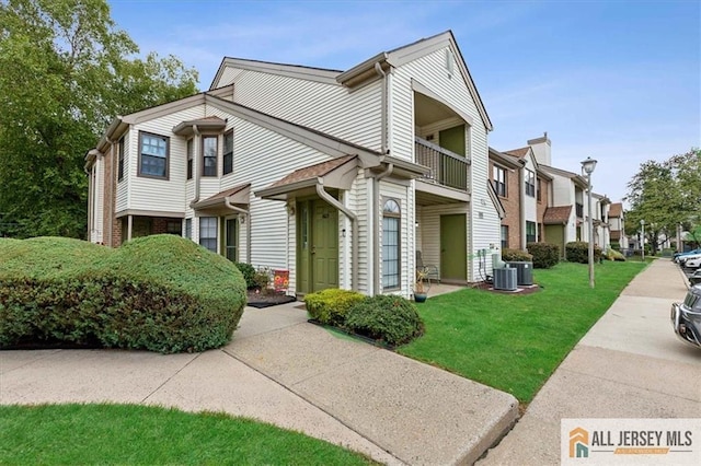1601 Pebble Pl Unit 1601, Sayreville, NJ 08859 - view of front facade featuring a residential view, central AC unit, a front yard, and a balcony
