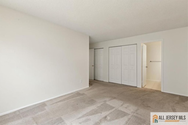 1601 Pebble Pl Unit 1601, Sayreville, NJ 08859 - unfurnished bedroom featuring baseboards, multiple closets, and carpet