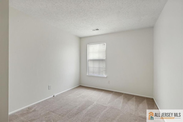 1601 Pebble Pl Unit 1601, Sayreville, NJ 08859 - carpeted empty room with a textured ceiling, visible vents, and baseboards