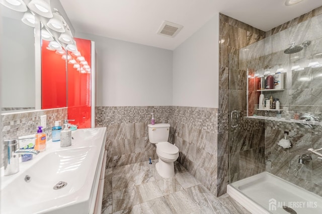 100-A George St, Carteret, NJ 07008 - full bathroom featuring tile walls, a stall shower, toilet, wainscoting, and marble finish floors