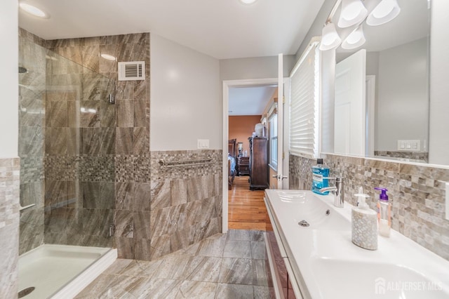 100-A George St, Carteret, NJ 07008 - bathroom featuring tile walls, a shower stall, connected bathroom, vanity, and a wainscoted wall