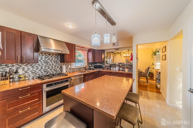 100-A George St, Carteret, NJ 07008 - kitchen featuring appliances with stainless steel finishes, wall chimney range hood, a sink, a breakfast bar area, and backsplash