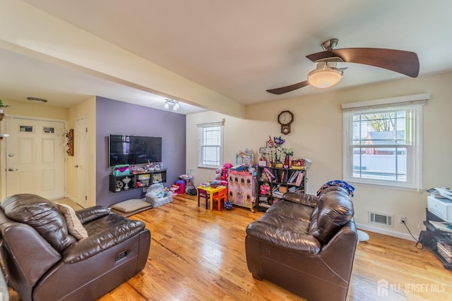 100-A George St, Carteret, NJ 07008 - living room featuring healthy amount of natural light, wood finished floors, a ceiling fan, and baseboards