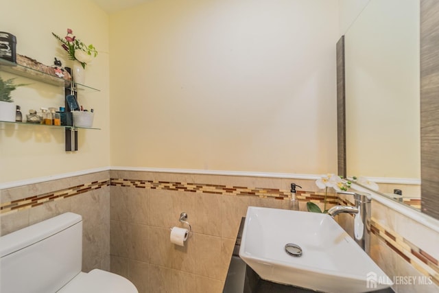 100-A George St, Carteret, NJ 07008 - bathroom with a sink, tile walls, toilet, and a wainscoted wall