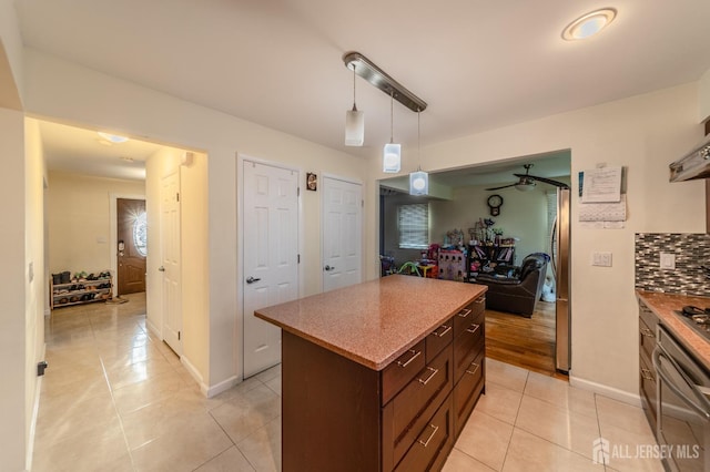 100-A George St, Carteret, NJ 07008 - kitchen with light tile patterned floors, a center island, tasteful backsplash, decorative light fixtures, and oven