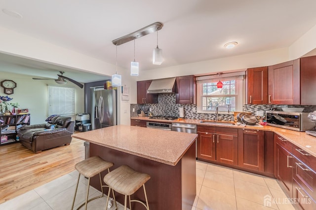 100-A George St, Carteret, NJ 07008 - kitchen featuring appliances with stainless steel finishes, wall chimney range hood, a sink, light tile patterned floors, and open floor plan
