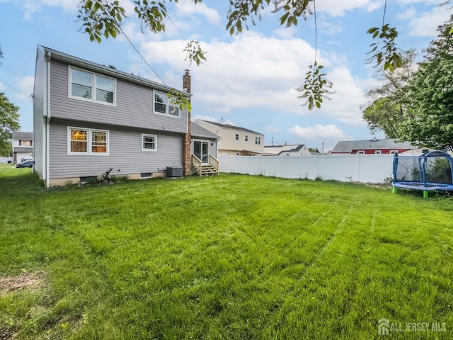 100-A George St, Carteret, NJ 07008 - back of property with entry steps, a trampoline, a chimney, and cooling unit