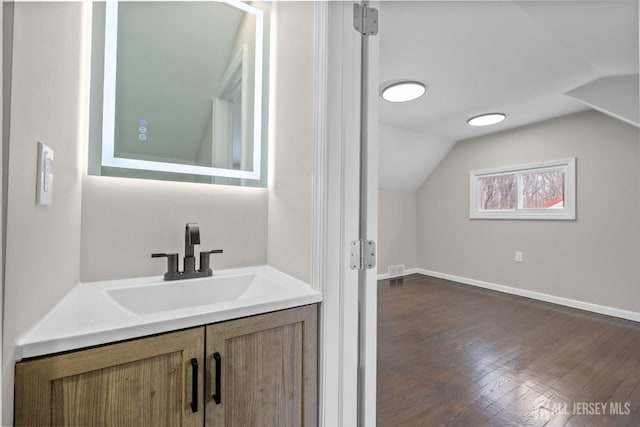 273 Park St, Franklin Twsp, NJ 08873 - bathroom with vaulted ceiling, wood finished floors, baseboards, and vanity