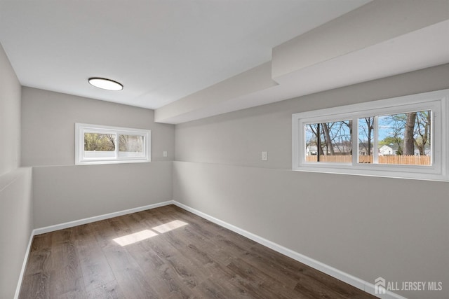 273 Park St, Franklin Twsp, NJ 08873 - basement featuring dark wood-type flooring, healthy amount of natural light, and baseboards