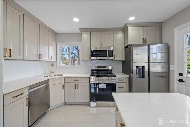 273 Park St, Franklin Twsp, NJ 08873 - kitchen with appliances with stainless steel finishes, a sink, tasteful backsplash, recessed lighting, and light stone counters