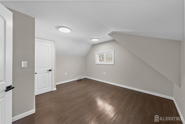 273 Park St, Franklin Twsp, NJ 08873 - additional living space featuring baseboards, dark wood finished floors, and vaulted ceiling