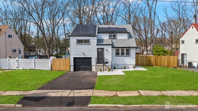 273 Park St, Franklin Twsp, NJ 08873 - view of front of home featuring solar panels, driveway, roof with shingles, a chimney, and a garage