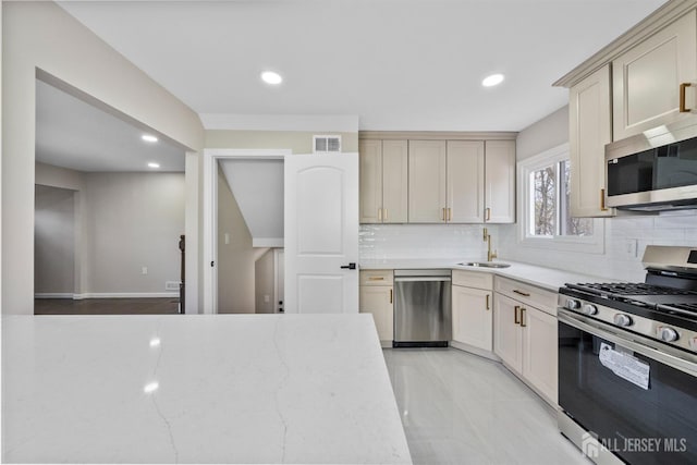 273 Park St, Franklin Twsp, NJ 08873 - kitchen with stainless steel appliances, a sink, backsplash, recessed lighting, and light stone countertops