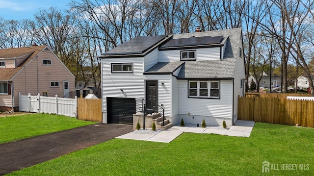 273 Park St, Franklin Twsp, NJ 08873 - back of house with solar panels, a garage, asphalt driveway, and roof with shingles