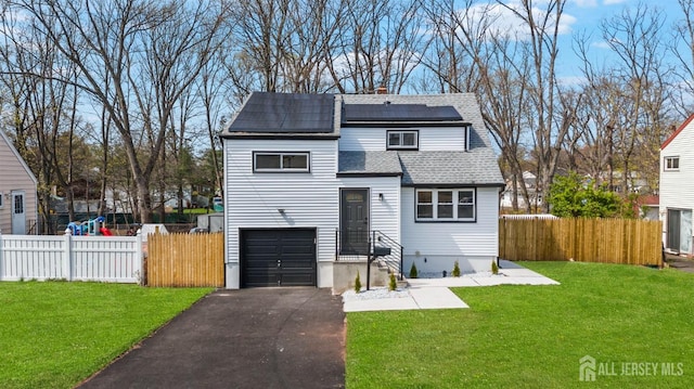 273 Park St, Franklin Twsp, NJ 08873 - view of front of home with asphalt driveway, roof mounted solar panels, roof with shingles, a chimney, and a garage