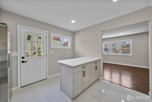 273 Park St, Franklin Twsp, NJ 08873 - kitchen with light countertops, baseboards, recessed lighting, light tile patterned floors, and freestanding refrigerator