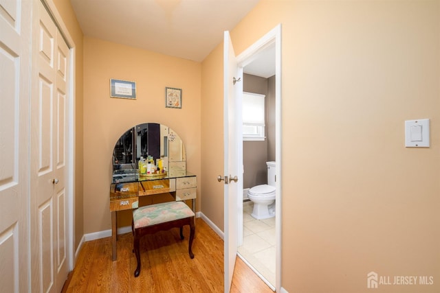 interior space with light wood finished floors and baseboards