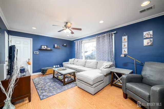 living area featuring wood finished floors, visible vents, recessed lighting, ceiling fan, and ornamental molding