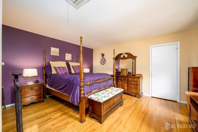 bedroom with baseboards and light wood finished floors