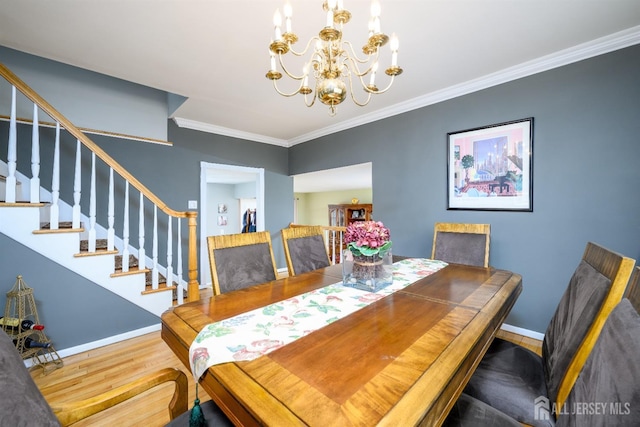 dining room with stairs, baseboards, wood finished floors, and crown molding