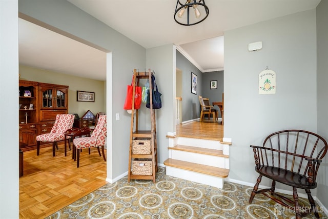 hallway featuring stairway, baseboards, and ornamental molding