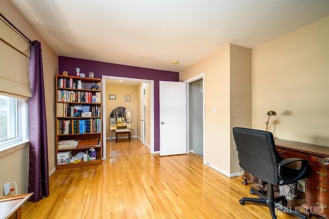 office area featuring light wood-style floors and baseboards