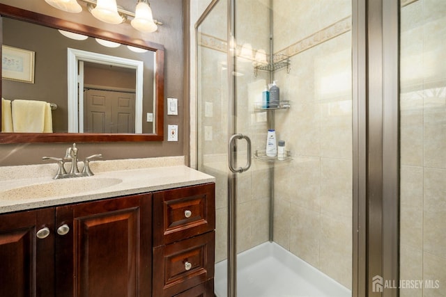 full bathroom with vanity and a stall shower