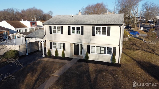 9 Huxley Dr, Old Bridge, NJ 08857 - view of front of property with a carport, asphalt driveway, a shingled roof, and a chimney
