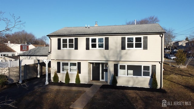 colonial home with roof with shingles and fence