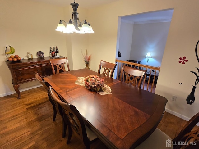 dining room featuring baseboards, an inviting chandelier, and wood finished floors