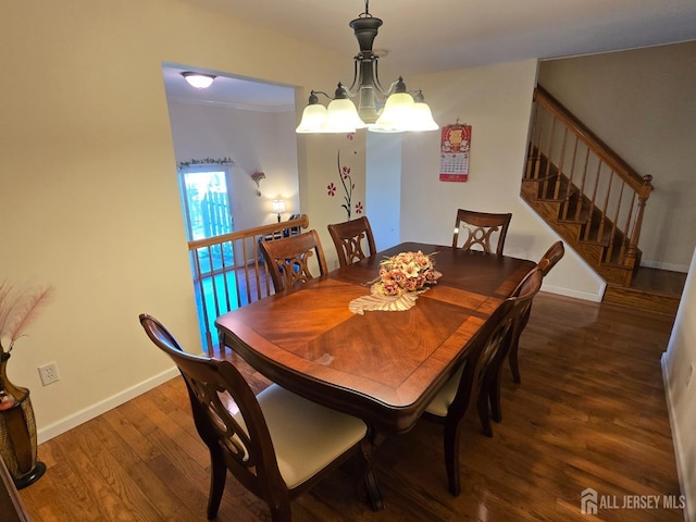dining area featuring baseboards, an inviting chandelier, wood finished floors, and stairway