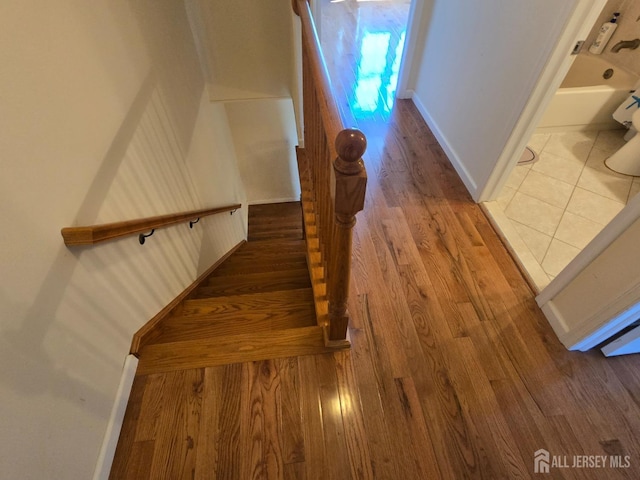 stairs featuring baseboards and wood finished floors