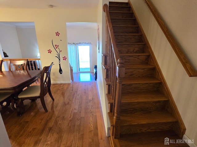 stairs with baseboards and wood finished floors