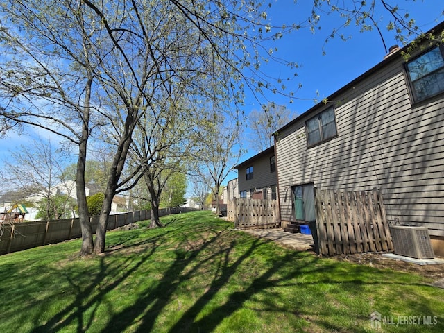 exterior space featuring central AC and fence