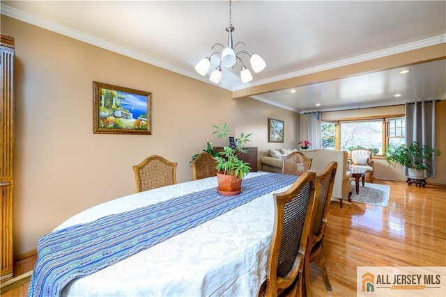 dining area with recessed lighting, a notable chandelier, crown molding, and light wood finished floors