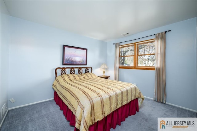 carpeted bedroom featuring baseboards and visible vents